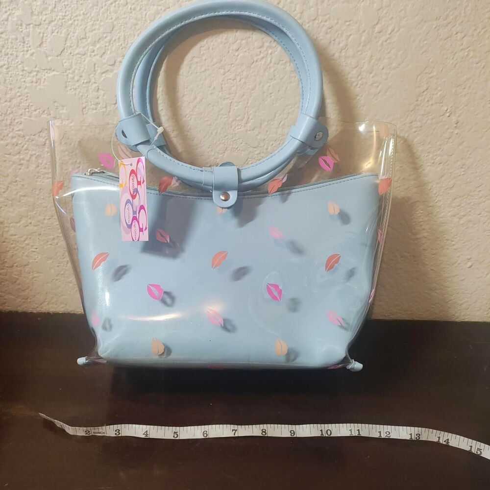 Blue and clear plastic handbag with pink and orange lip design